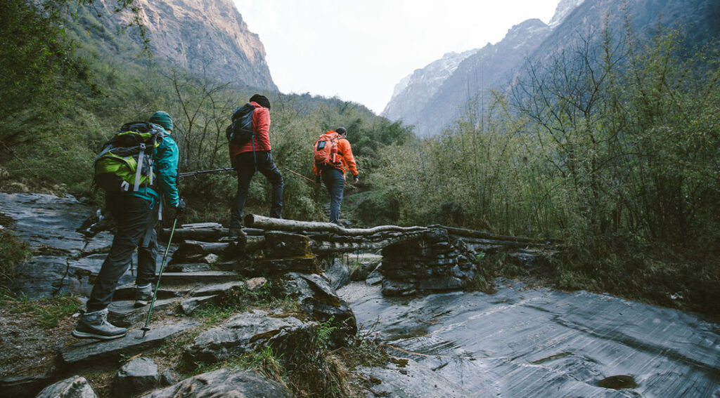 A Group Of Hikers Hiking Through A Wet Terrain Hiking Trail 1024x567