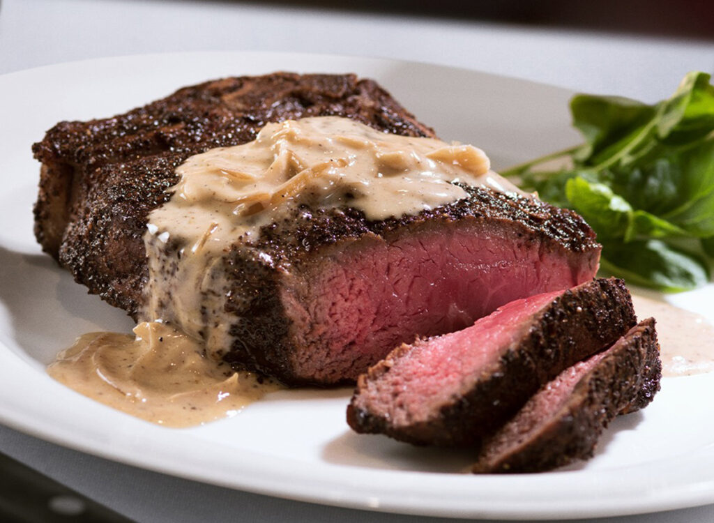 4 Common Steakhouses With the Highest "Espresso-Rubbed" Steaks, Consistent with Diners the capital grille kona crusted dry aged bone in new york strip.jpg
