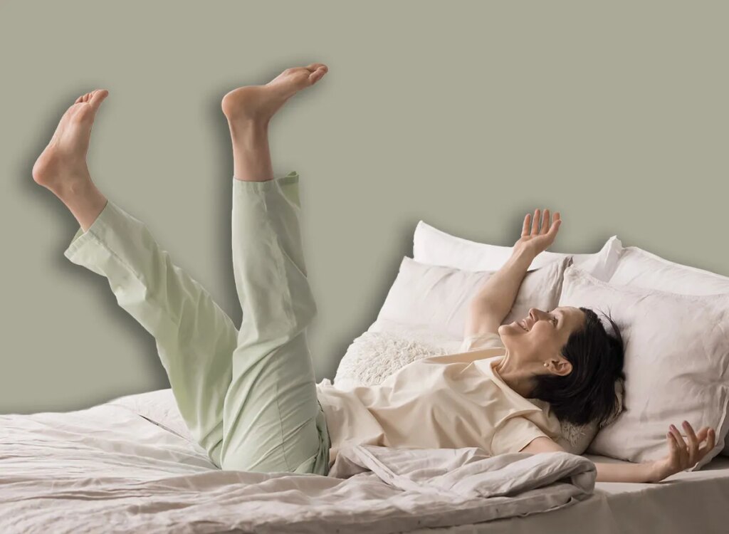 happy woman bed exercise 2695668699.jpg