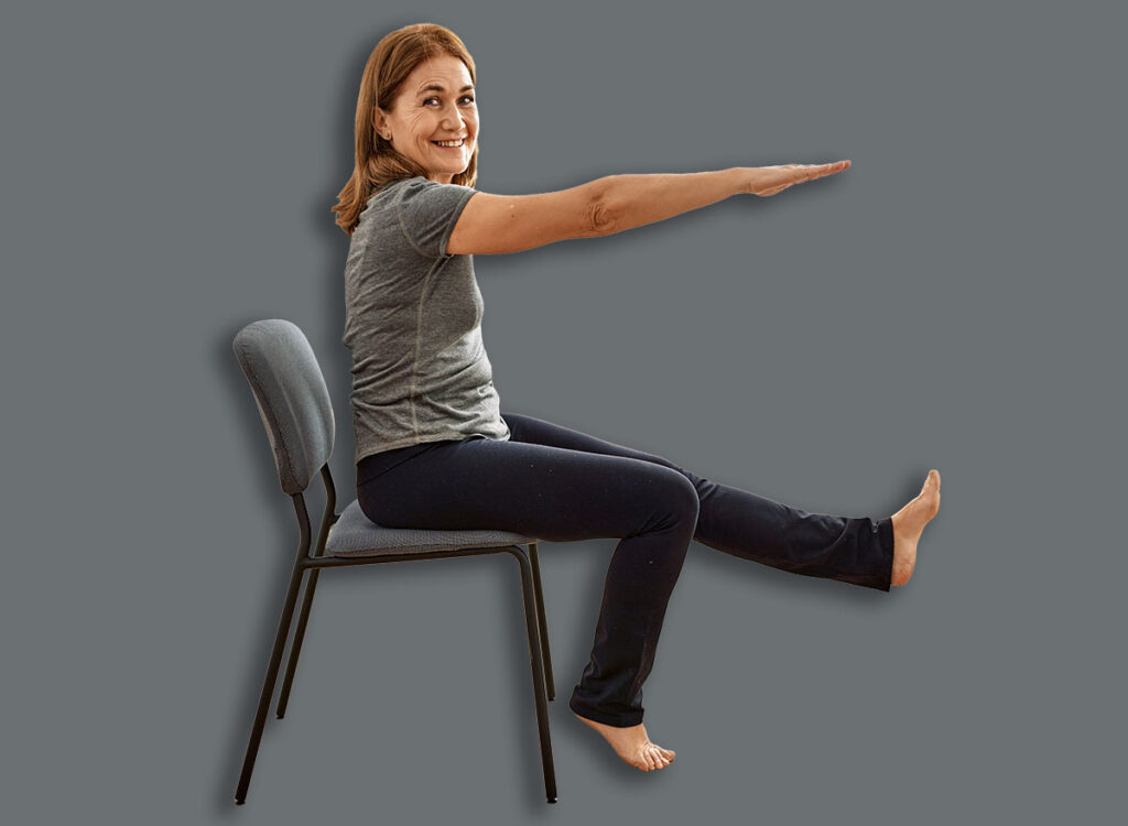 woman chair leg raise exercise 2190259057.jpg
