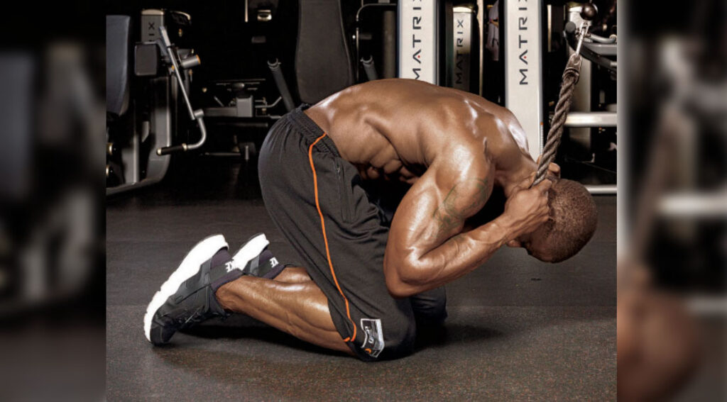 athletic muscular man performing a rope crunch exercise.jpg