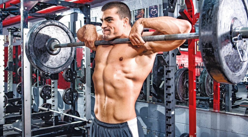 Are Upright Rows Unhealthy for Shoulders? The right way to Construct Larger Delts With out Damage bodybuilder working out his shoulders with upright rows exercise.jpg