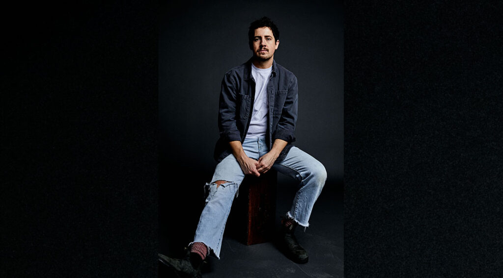 indy music star michael marcagi sitting on a stool.jpg