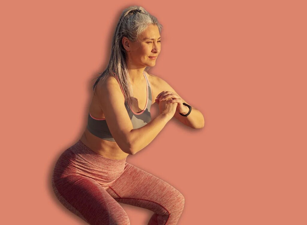 mature woman bodyweight squats exercise 2108645519.jpg