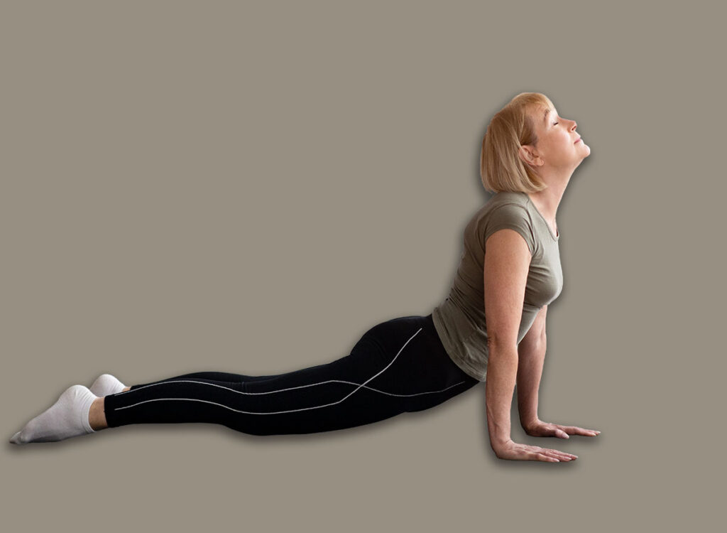 mature woman cobra pose yoga exercise 1945425316.jpg