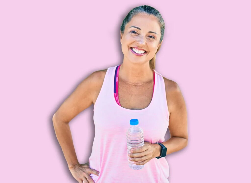 mature woman holding a bottle of water 1794379522.jpg