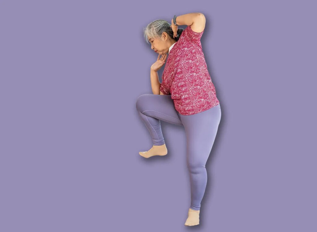 mature woman standing side crunches exercise 1933623416.jpg