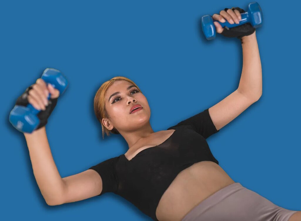 woman dumbbell floor press exercise 2231733139.jpg