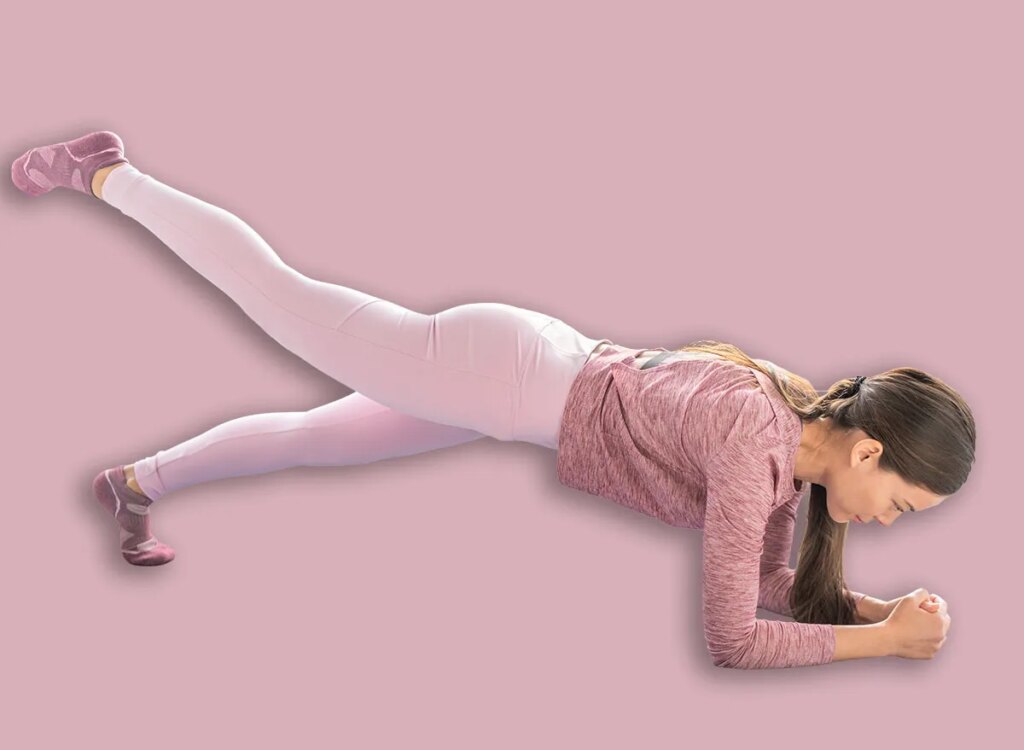 5 Morning Workouts To Repair Core Energy After 50 woman plank with leg lift exercise 1730514109.jpg