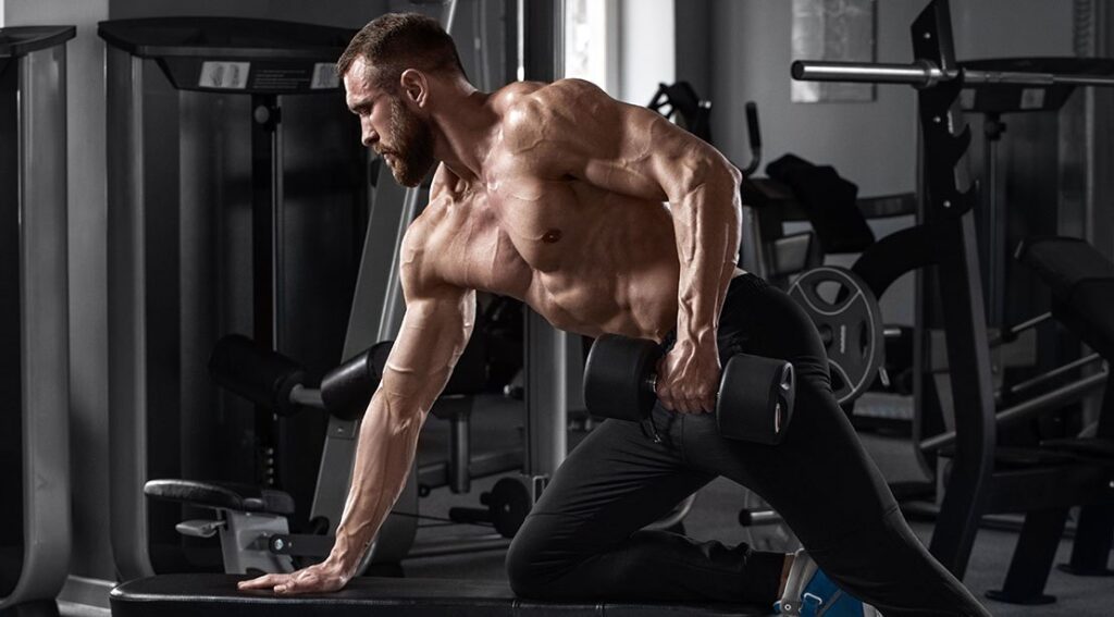 young muscular fit athletic man using muscle building workouts to optimize his physique.jpg